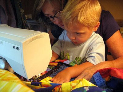 Simon helps Baba sew his new quilt