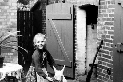 My wife with a neighbor's goat,  Germany 1953 .