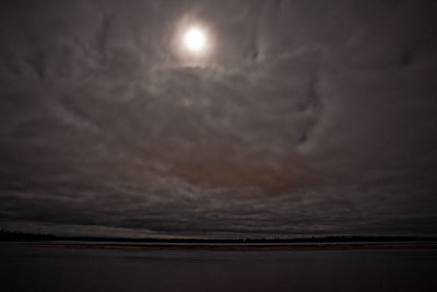 Moon and clouds over the Moose River at night