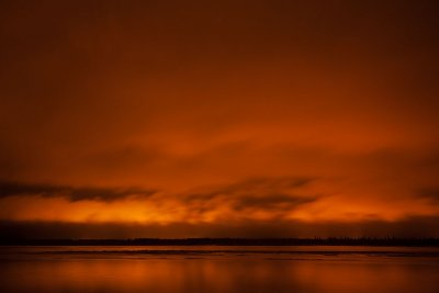 Night time clouds lit up by lights of Moose Factory