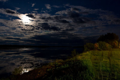 Night view showing reflected clouds looking up river