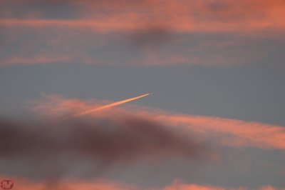 Pink clouds with arrow at sunset