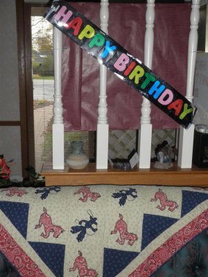 B-day sign and Zack's cowboy quilt on sofa