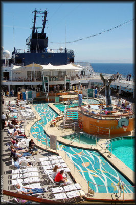 The deck is filled with swimming pools and lounge chairs