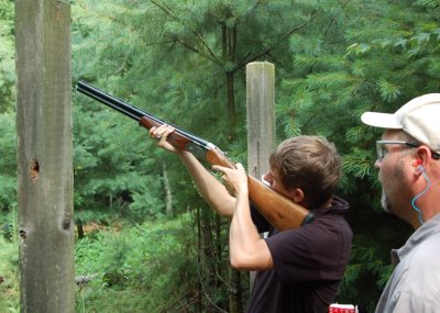 Guide Mike Woodruff gives Tyler some tips on clay shooting