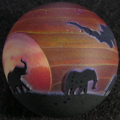 One of the neatest marbles ever, with a whole family of elpehants marching through the sunset.