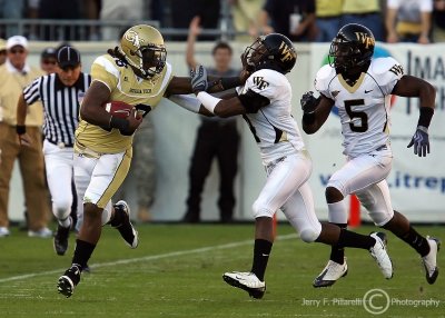 Yellow Jackets A-back Anthony Allen stiff arms Demon Deacons CB Josh Bush