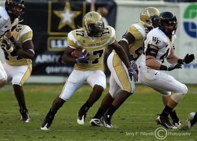 Yellow Jackets A-back Orwin Smith runs through the Demon Deacons defense