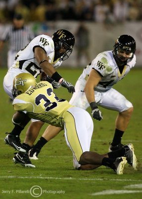Georgia Tech DB Mario Edwards tackles Wake Forest RB Brandon Pendergrass in the open field