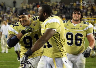 Jackets teammates DE Derrick Morgan, DE Anthony Egbuniwe and DT Logan Walls celebrate the 30 – 27 overtime victory