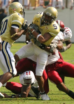 WR Greg Smith fights for extra yardage
