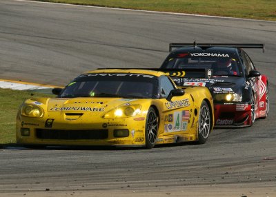 A Corvette moves through turn 10B followed closely by a BMW