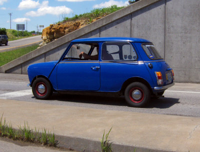 My wife saw this car tooling down the road. Had we the time, I'd have followed him & asked to photograph this car properly. I know it's a British Mini Cooper, but I don't know the year or the model. Notice the stering wheel is on the left side.