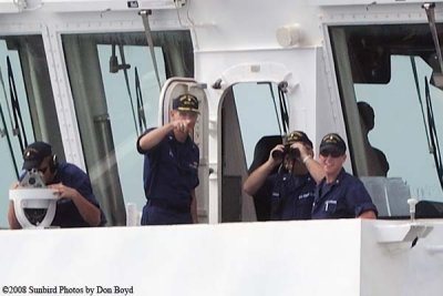 The USCGC BERTHOLF's Commanding Officer, CAPT Patrick Stadt, pointing as they transit through Government Cut, photo #1964C