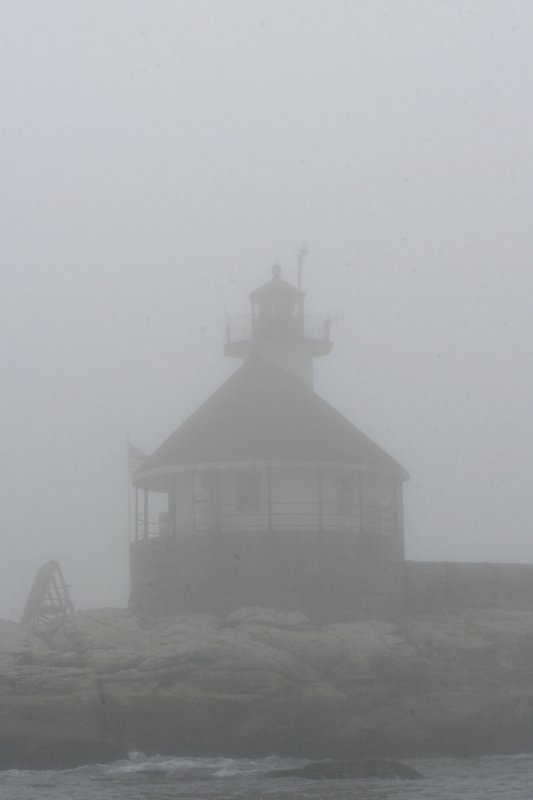 Tiny octagonal Cuckolds lighthouse in the fog.