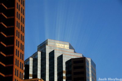 Rays of light reflecting up from an office building