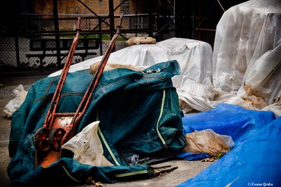 Red hand truck on green tarp
