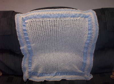 This photo makes this blanket appear to be white with light blue.  In reality the main blanket is a pale baby blue and the border is a sky blue.