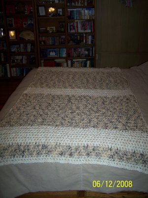 I laid this couch afghan completely open across the foot of our bed - to show the whole design, which would have been unnoticed had it been folded on the back of a couch.