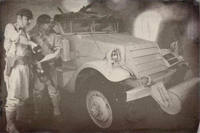 Officers beside Scout Car