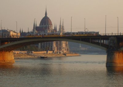 a tram crossing the bridge, parliament in back