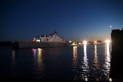 USS Freedom with tug, tying up to the pier