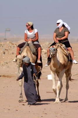 Cameleer, guiding two tourists, Hurghada