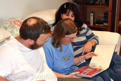 Debbie gives the scrapbook to Helen and Dan