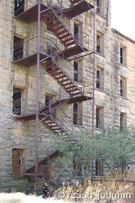 A zig-zag steel stairway leads to each floor