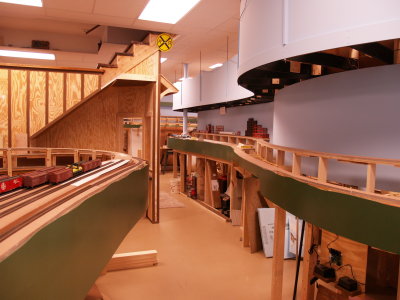 The lower level benchwork roadbed in place. View looking towards TV Town on the right.
