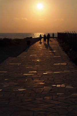 Joggers on Pafos Coastal Walk at Sunset