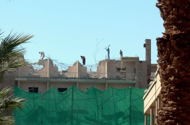 These people are literally knocking down a building right under their feet