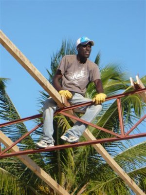 Frantz sitting upon the roof  waiting on the next board to be handed up to him