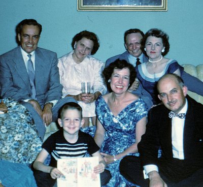 1956: Bolling AFB, Washington,  DC. Mom and Dad upper right. Me in front with Dick and Jane reader.