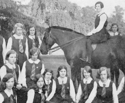1931: Clapham Notre Dame Convent, London. Mom (far left middle row). Alethea (far right standing behind horse).
