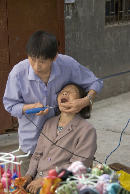 Dentist and Patient in Fengdu Marketplace