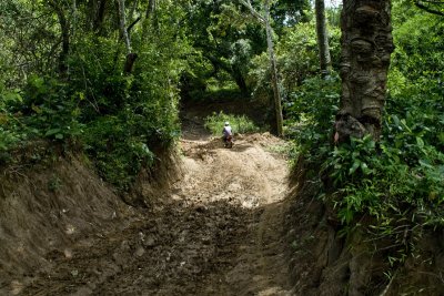 Mr. Has, my guide, riding down a muddy hill. I had to walk it.