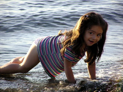 Cute little girl looking for shells