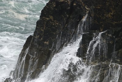 'waterfall' created by water returning after splashing up the rocks