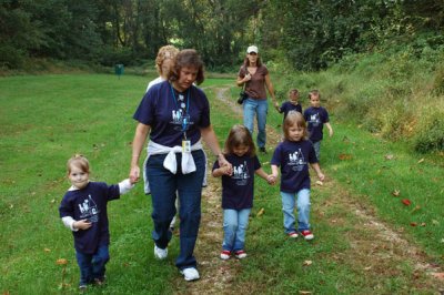 Reagan holding hands with one of her teachers and Rory