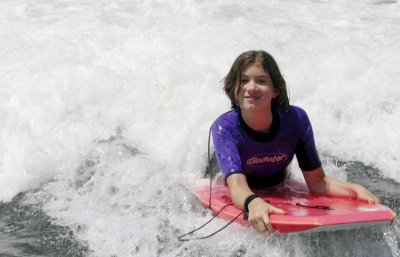nicole rides a wave