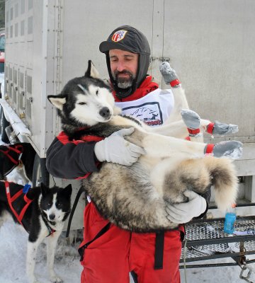 Musher Embraces His Dog After A Good Run