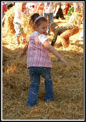 Noelle gets in a hay throwing competition with some other kids
