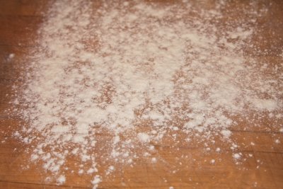Moisten your work surface.  Lay down a piece of wax paper and sprinkle with flour