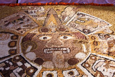 Intricate images made up of seeds and corn are constructed on the ground in front of the altars.
