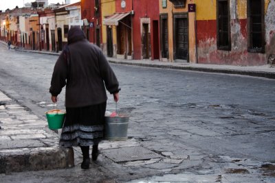 Women pick up freshly made tortillas in their pails...