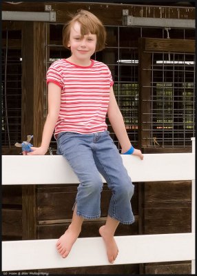 Smiling girl on fence