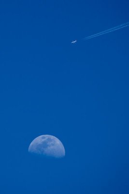 Airplane Flying by the Moon