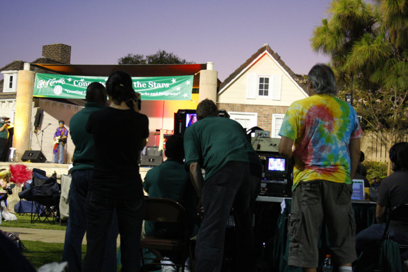 A picture of someone taping the guys monitoring the taping of the concert