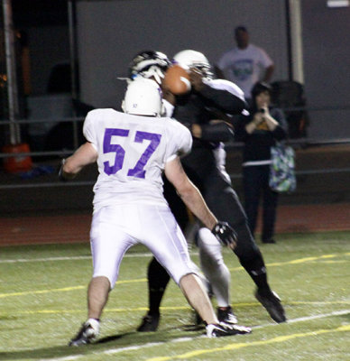 Jensen in on a fumble-causing QB sack